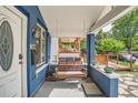 Cozy front porch featuring a swing, stylish lighting and lovely outdoor space at 2838 Decatur St, Denver, CO 80211
