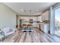 Bright kitchen with white cabinets, stainless steel appliances, and hardwood floors at 6307 Saddle Bow Ave, Parker, CO 80134