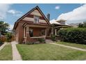Inviting exterior showcasing the home's brick facade, landscaped lawn, and driveway at 461 S Sherman St, Denver, CO 80209