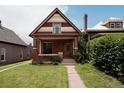 Charming brick home featuring a lovely front porch, walkway and green lawn at 461 S Sherman St, Denver, CO 80209