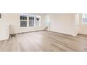 Bright living room with hardwood floors and large windows, offering plenty of natural light at 2138 S Haleyville Way, Aurora, CO 80018