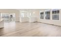 Spacious living area featuring hardwood floors and multiple windows for ample sunlight at 2138 S Haleyville Way, Aurora, CO 80018