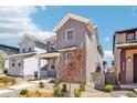 Stylish two-story home with gray siding and neat landscaping in a residential neighborhood at 8785 Whiteclover St, Littleton, CO 80125