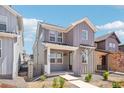 Attractive two-story home with modern siding, covered porch, and well-maintained landscaping at 8785 Whiteclover St, Littleton, CO 80125