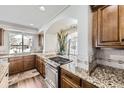 Kitchen showcases granite countertops, stainless steel appliances, and a gas range at 5072 Cathay St, Denver, CO 80249