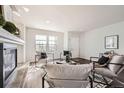 Bright living room with a fireplace, stylish decor, and hardwood floors at 5072 Cathay St, Denver, CO 80249