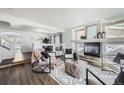 Bright living room with a fireplace, stylish decor, and hardwood floors at 5072 Cathay St, Denver, CO 80249