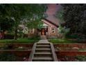 Lovely brick home with a red tile roof, landscaped yard and inviting entryway at 2232 S Ogden St, Denver, CO 80210