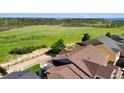 View of lush green space beyond the rooftops of a beautiful residential neighborhood at 3745 Spanish Oaks Trl, Castle Rock, CO 80108