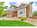 Charming two-story home with well-manicured lawn, brick accents, and a two-car garage at 3745 Spanish Oaks Trl, Castle Rock, CO 80108