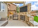 Outdoor kitchen with a built-in grill, countertops, and ample space for entertaining at 3745 Spanish Oaks Trl, Castle Rock, CO 80108