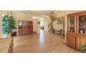 Large living room space with hardwood floors, staircase, and great natural light at 9586 W Victoria Dr, Littleton, CO 80128