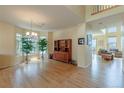 Spacious living room with hardwood floors, lots of light, and a decorative cabinet at 9586 W Victoria Dr, Littleton, CO 80128