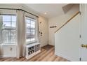 Inviting entryway with natural light, a convenient bench with storage, and a coat rack for added organization at 9573 Deerhorn Ct # 19, Parker, CO 80134