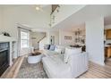 Airy open floor plan with a cozy fireplace, vaulted ceilings, and seamless flow into the dining area at 9573 Deerhorn Ct # 19, Parker, CO 80134