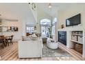 Open-concept living room with fireplace, neutral furniture, and vaulted ceiling, creating a welcoming atmosphere at 9573 Deerhorn Ct # 19, Parker, CO 80134