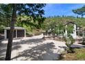 Stunning home exterior featuring a multi-car garage and lush greenery on a spacious lot at 6123 Buffalo Run, Littleton, CO 80125