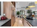 Modern kitchen with sleek cabinetry, hardwood floors, and an open-concept dining area at 6123 Buffalo Run, Littleton, CO 80125