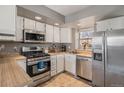 Efficient kitchen with stainless steel appliances, ample cabinet space, and natural light, perfect for cooking at 984 S Pitkin Ct, Aurora, CO 80017