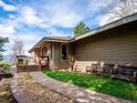 Side view of house with stone pathway and inviting deck create curb appeal at 24172 Jerome Ct, Golden, CO 80401