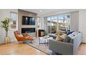 Bright living room with modern fireplace, large sliding glass doors, and stylish decor at 2248 S Lincoln St, Denver, CO 80210