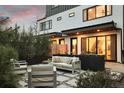 Relaxing backyard patio area with modern outdoor seating and lush greenery surrounding the perimeter at 2248 S Lincoln St, Denver, CO 80210
