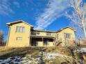 Two-story home with a large deck and snow-dusted yard at 6861 Oberon Rd, Arvada, CO 80004