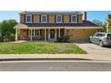 Charming two-story home with brick accents, a covered porch, and solar panels on the roof at 3285 W 11Th Avenue Ct, Broomfield, CO 80020