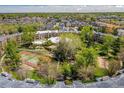 Aerial view of condo complex with community pool, tennis courts, and lush greenery on a sunny day at 1306 S Parker Rd # 162, Denver, CO 80231