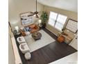 An aerial view of a bright living room with a ceiling fan and modern décor at 3495 Amber Sun Cir, Castle Rock, CO 80108