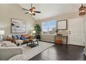 Cozy living room with hardwood floors, large windows, and stylish furnishings at 3495 Amber Sun Cir, Castle Rock, CO 80108
