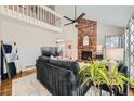 Spacious living room with a brick fireplace and an open layout. Lots of natural light at 17509 E Kenyon Dr, Aurora, CO 80013