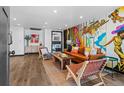 Stylish living room with unique wall art, hardwood floors, and modern furniture at 3275 W Hawthorne Pl, Denver, CO 80221