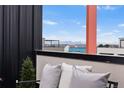Relaxing balcony offers beautiful mountain views beyond neighboring rooftops, creating a peaceful urban retreat at 3040 Wilson Ct # 2, Denver, CO 80205