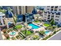 An aerial view showcasing a luxurious pool and garden area surrounded by elegant architecture in an urban setting at 925 N Lincoln St # 14C, Denver, CO 80203