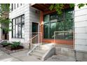 Exterior view showing entryway stairs and facade with a mix of brick and siding at 3100 Huron St # 1B, Denver, CO 80202