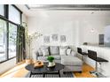 Cozy living room with a comfortable gray sofa, modern decor, and hardwood floors at 3100 Huron St # 1B, Denver, CO 80202