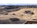 A picturesque view of a new home community and landscape with cloudy skies at 4261 Ridgewalk Pt, Castle Rock, CO 80108