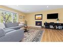 Comfortable living room with a fireplace, large window, and cozy furniture at 15000 W 29Th Ave, Golden, CO 80401