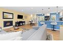 Bright living room with a fireplace, modern furniture and updated kitchen in the background at 15000 W 29Th Ave, Golden, CO 80401