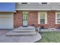 Inviting front entrance with steps, brick detail, and well-manicured landscaping, showcasing home's curb appeal at 17825 E Carolina Pl, Aurora, CO 80017