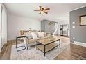 Bright living room with open layout, hardwood floors, and neutral decor at 3308 E 118Th Way, Thornton, CO 80233