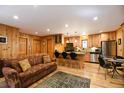 Open concept living space with an adjacent kitchen featuring a granite countertop island and bar seating at 446 Blue River Rd, Breckenridge, CO 80424