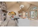 Inviting living room features stone fireplace, vaulted ceilings, and natural light at 6530 Ridgeview Dr, Morrison, CO 80465