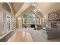Bright living room with vaulted ceiling, stone fireplace, and large windows at 6530 Ridgeview Dr, Morrison, CO 80465