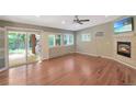Inviting living room with a fireplace, hardwood floors, and sliding doors leading to the outdoor space at 6684 E Bates Ave, Denver, CO 80224