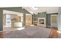 Bright living room with a cozy fireplace, hardwood floors, and an open layout connecting to the kitchen at 6684 E Bates Ave, Denver, CO 80224