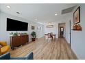Bright living room featuring wood floors, dining area, and fresh, white paint at 1947 Jay St, Lakewood, CO 80214