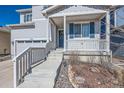 Inviting front porch with decorative wreath and concrete steps leading to the entrance at 4327 Wilson Peak Dr, Castle Rock, CO 80104
