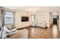 Spacious living room with hardwood floors, neutral paint, large sectional, and flat screen TV at 4327 Wilson Peak Dr, Castle Rock, CO 80104